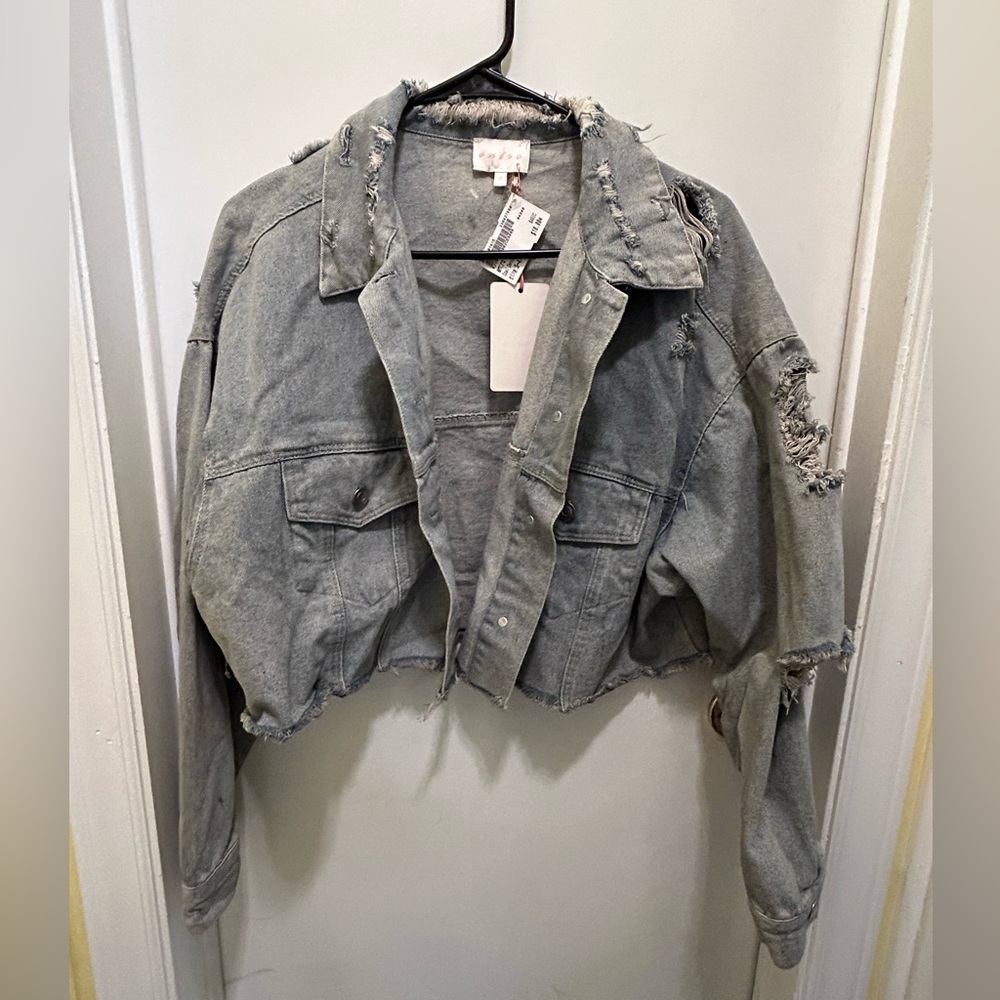 Distressed denim crop jacket NWT says S/M size, but could fit up to a large.